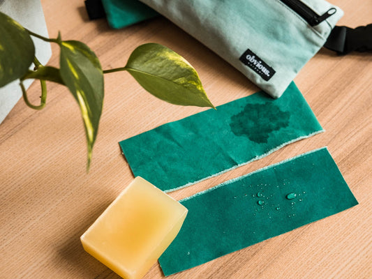 Water repellent waxed cotton with water drops and regular cotton absorbs water. Recycled tent material, IWATO